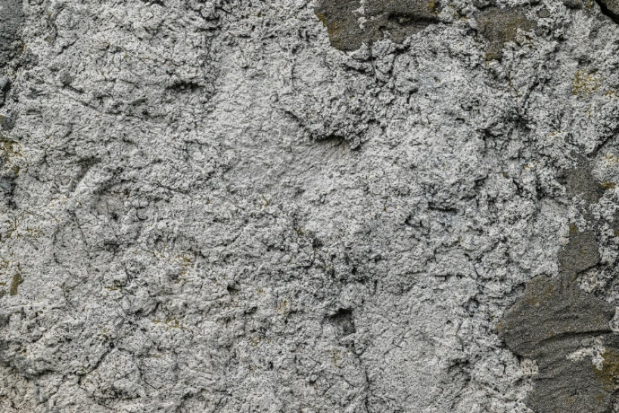 Rough, textured concrete wall up close.