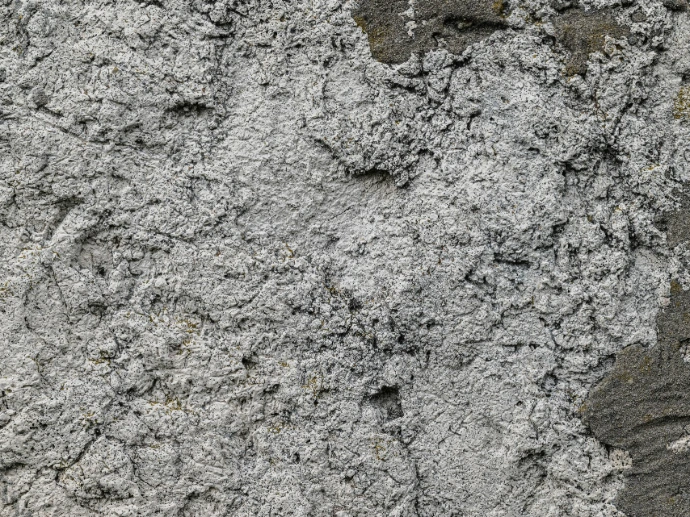 Rough, textured concrete wall up close.