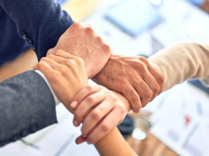 person in black long sleeve shirt holding persons hand